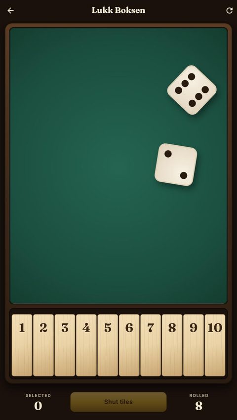 A game in progress: two dice on a green felt tray above the ten tiles